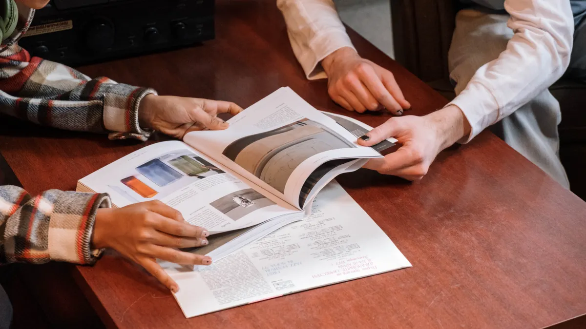 Two people reviewing a brochure at a table